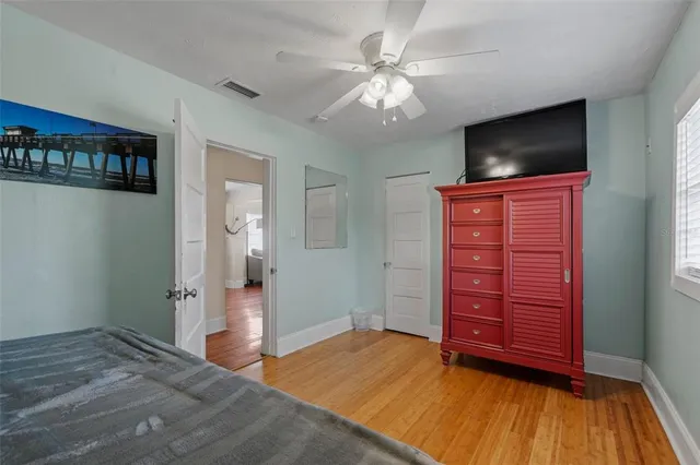 a view of a bedroom with closet and flat screen tv