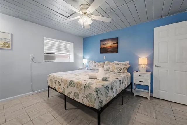 a bedroom with bed and a chandelier