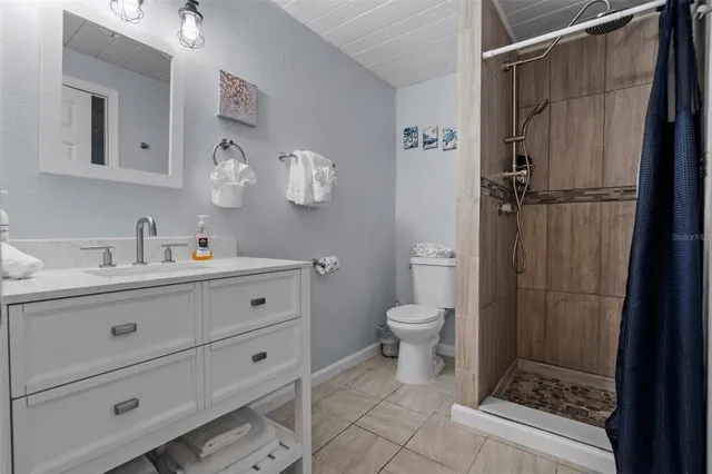 a bathroom with a sink mirror vanity and toilet