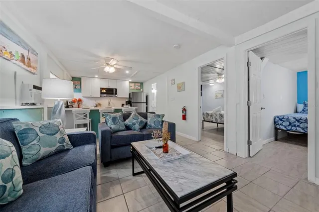 a living room with furniture and a view of kitchen