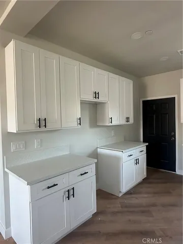 a kitchen with a white cabinets and sink