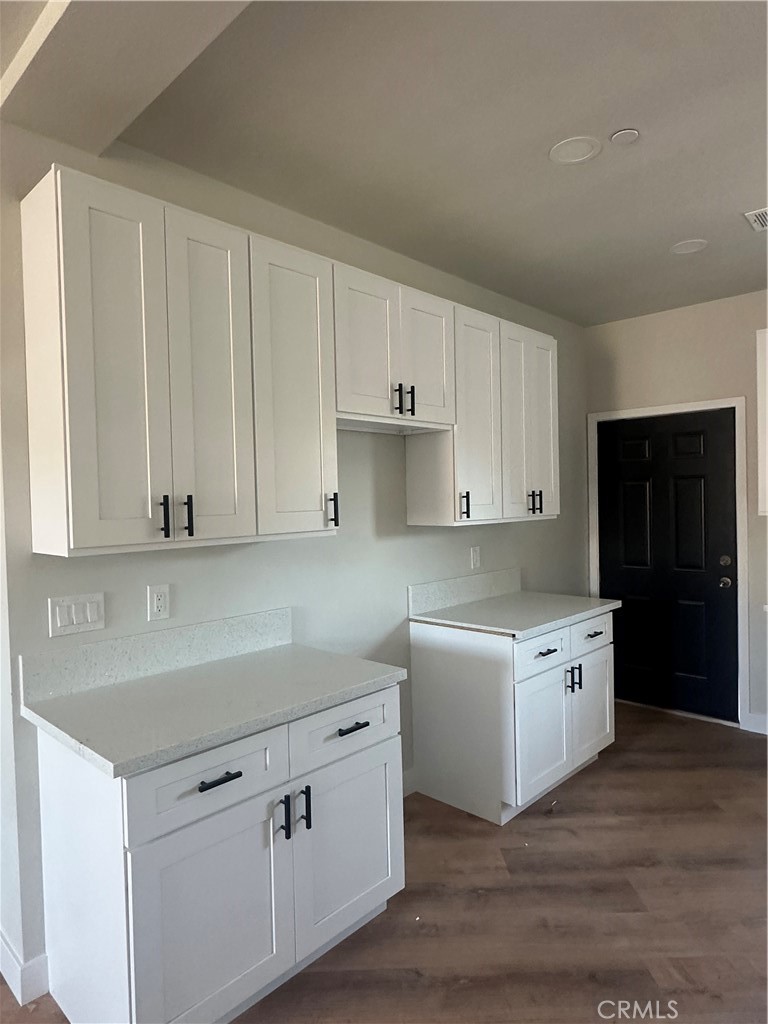 6597 Valaria Drive Highland, CA 92346 - Photo 2 of 8 a kitchen with a white cabinets and sink