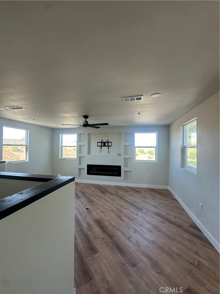 6597 Valaria Drive Highland, CA 92346 - Photo 3 of 8 a view of an empty room with window and wooden floor