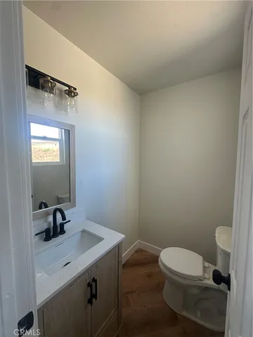 a bathroom with a sink a toilet and mirror
