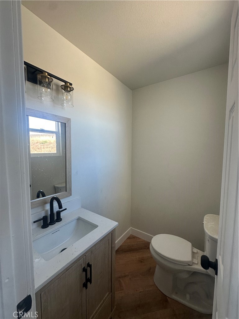 6597 Valaria Drive Highland, CA 92346 - Photo 4 of 8 a bathroom with a sink a toilet and mirror
