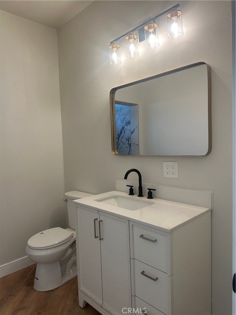6597 Valaria Drive Highland, CA 92346 - Photo 6 of 8 a bathroom with a toilet sink and mirror