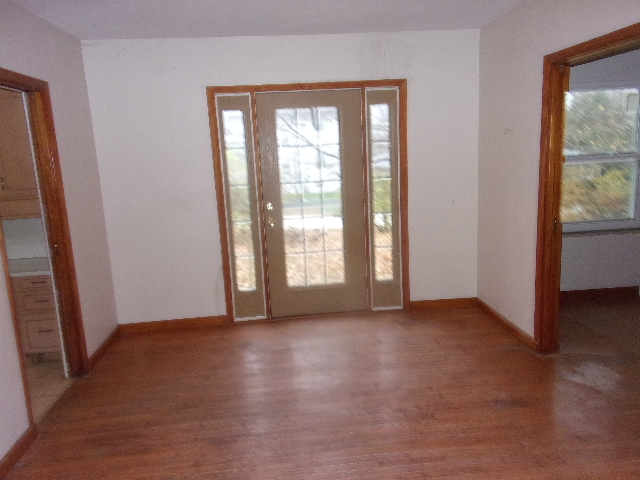 102 West Center Street Le Roy, IL 61752 - Photo 5 of 11 an empty room with wooden floor and windows