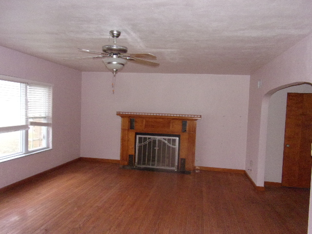 102 West Center Street Le Roy, IL 61752 - Photo 6 of 11 an empty room with windows and fireplace