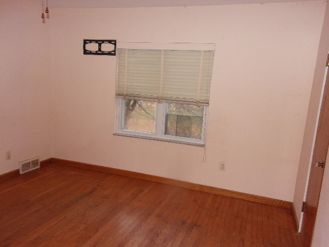 102 West Center Street Le Roy, IL 61752 - Photo 9 of 11 an empty room with wooden floor and windows