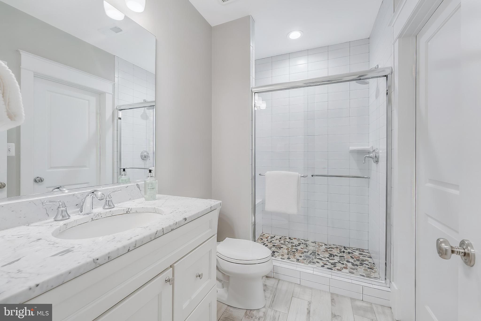 6805 Lumsden Street McLean, VA 22101 - Photo 103 of 123 a bathroom with a granite countertop sink toilet and shower