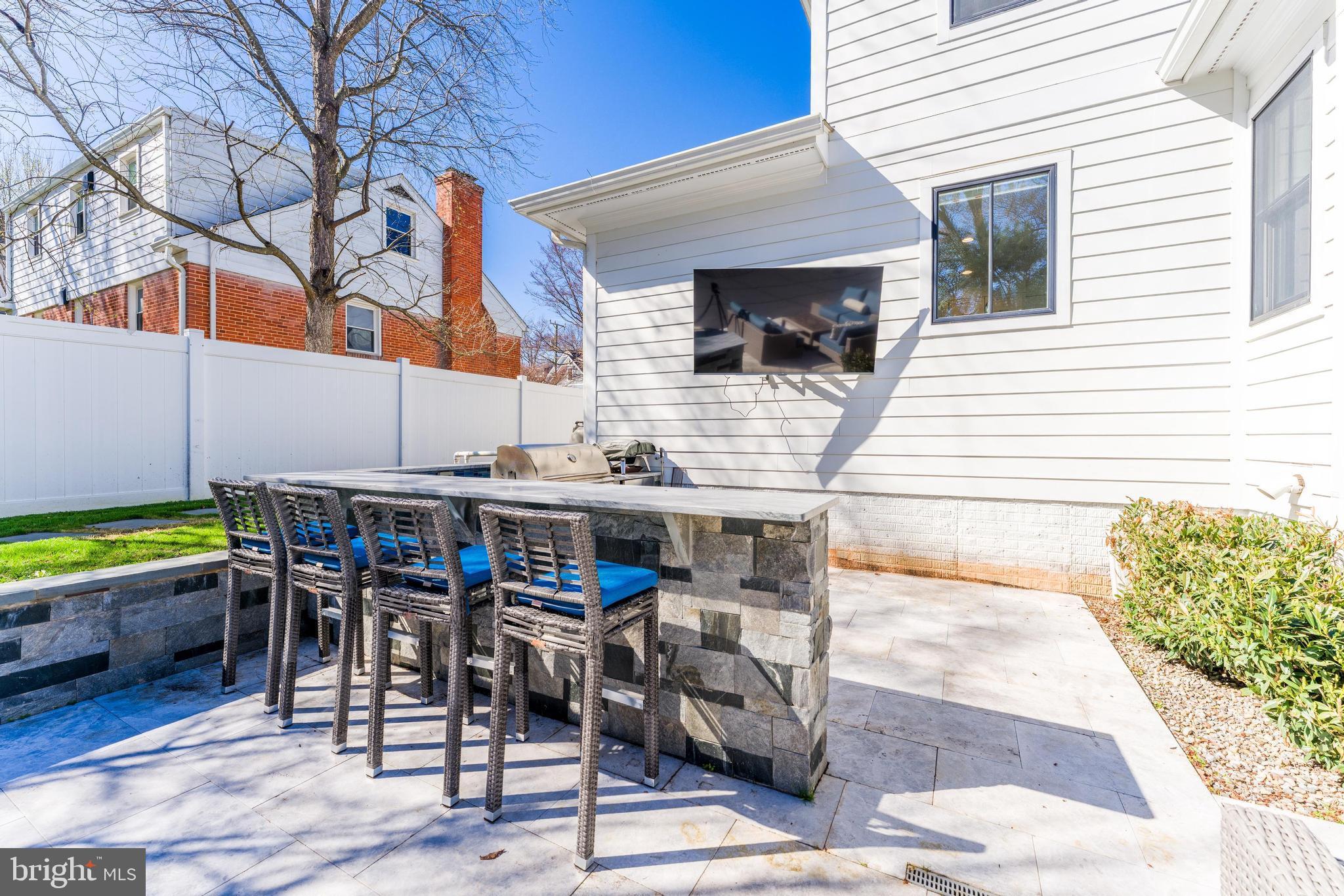 6805 Lumsden Street McLean, VA 22101 - Photo 6 of 123 a view of a patio with table and chairs with wooden floor and plants