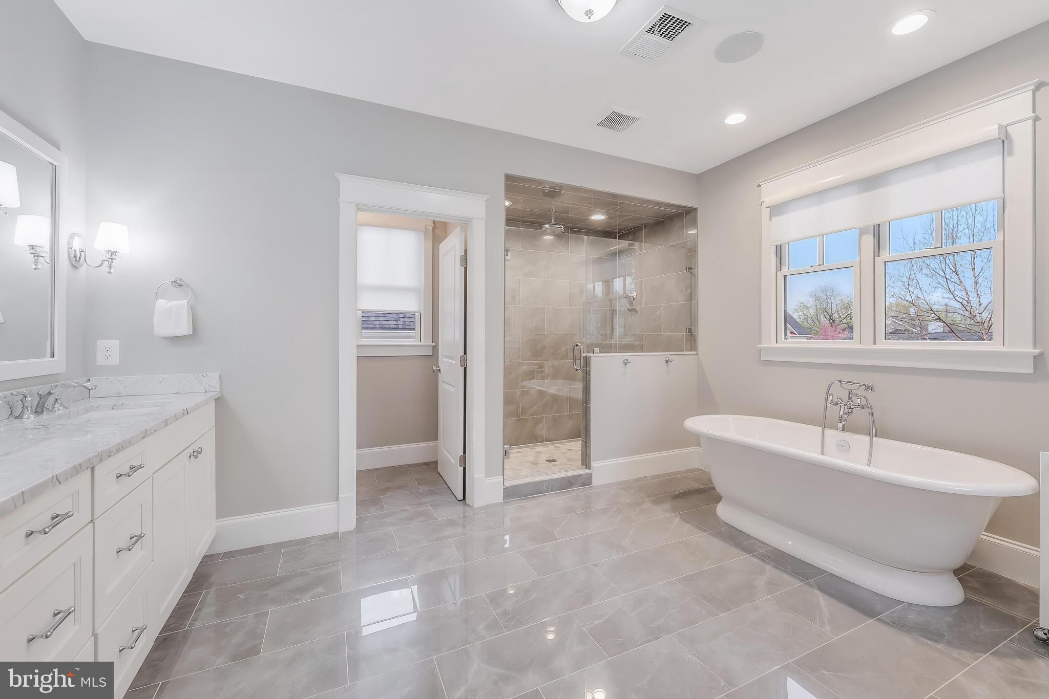 6805 Lumsden Street McLean, VA 22101 - Photo 70 of 123 a spacious bathroom with a granite countertop tub shower double sink and a mirror