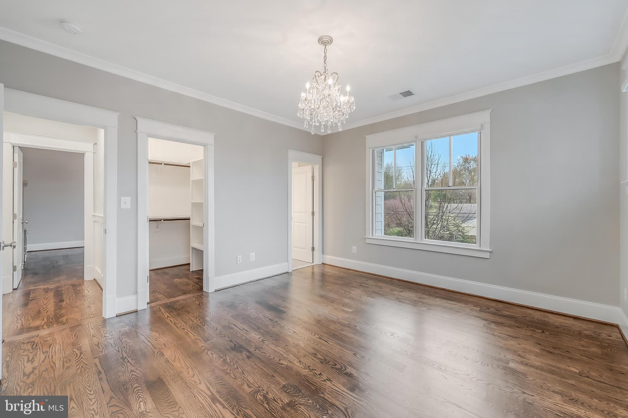 6805 Lumsden Street McLean, VA 22101 - Photo 77 of 123 an empty room with wooden floor chandelier and windows