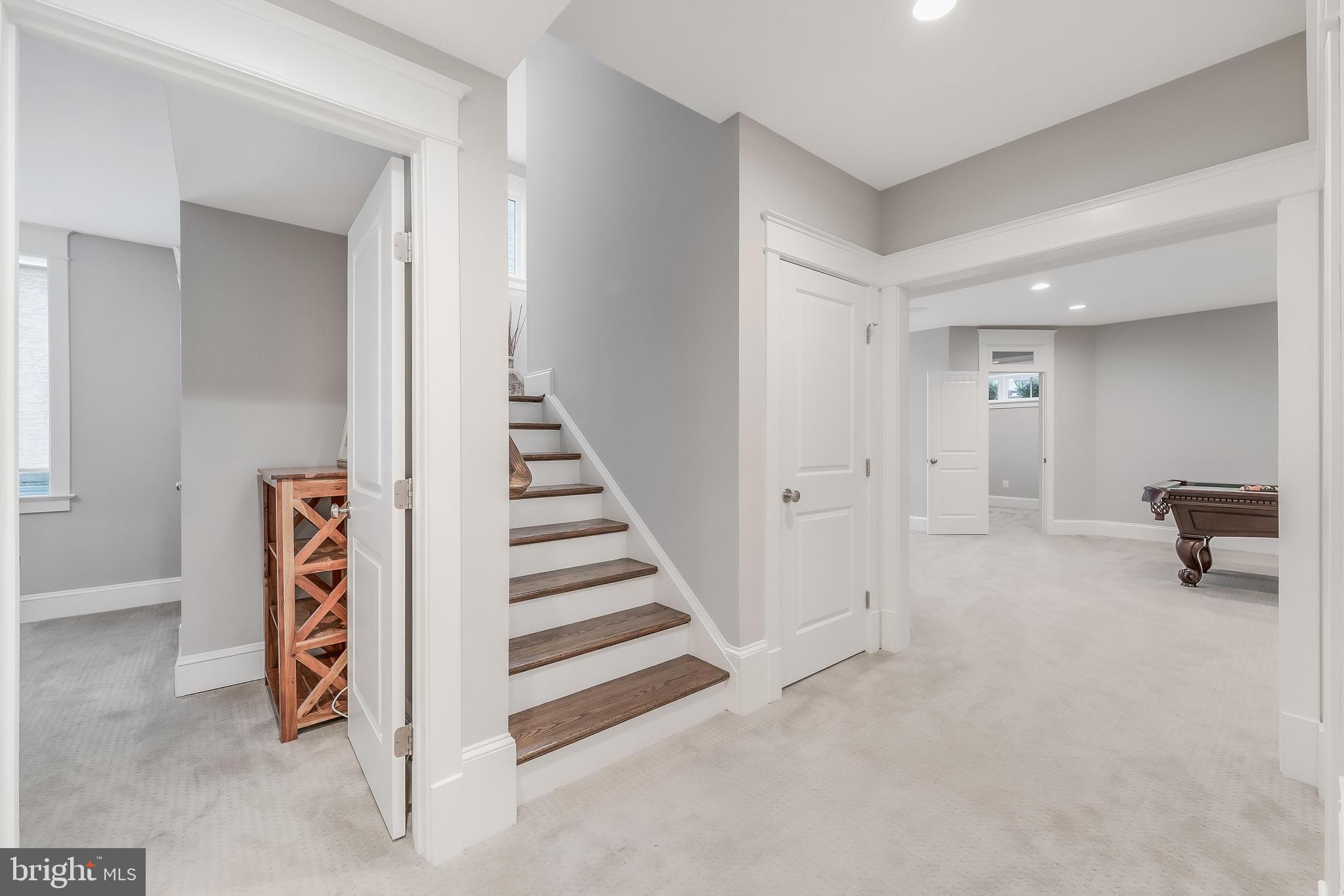 6805 Lumsden Street McLean, VA 22101 - Photo 94 of 123 a view of a hallway with entryway stairs and a livingroom with furniture