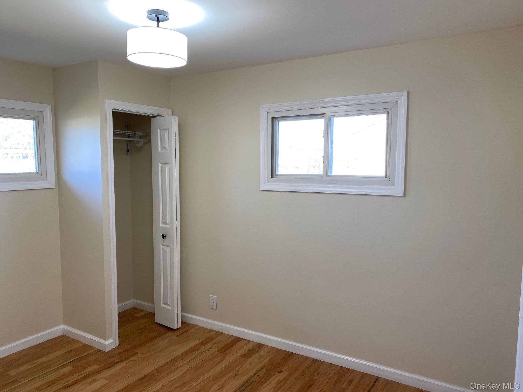 5 Smith Road Cornwall, NY 12518 - Photo 28 of 32 Bedroom 3 - Unfurnished bedroom with a closet, light wood-type flooring, and multiple windows