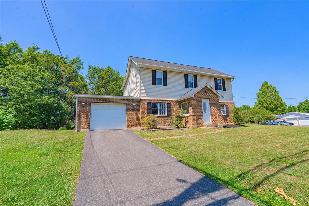 4165 East Texas Road Allentown, PA 18103 - Photo 2 of 56 A classic brick and siding residence with an attached garage, nestled on a verdant lot.