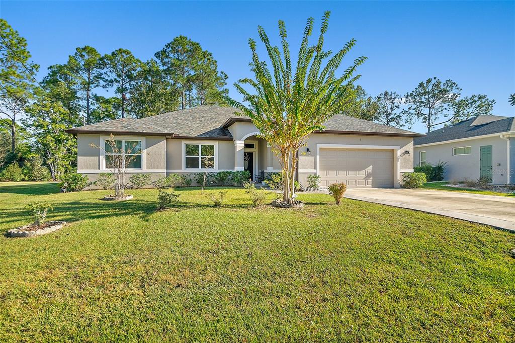 6 Wavecrest Place Palm Coast, FL 32164 - Photo 1 of 22 a front view of house with yard and trees