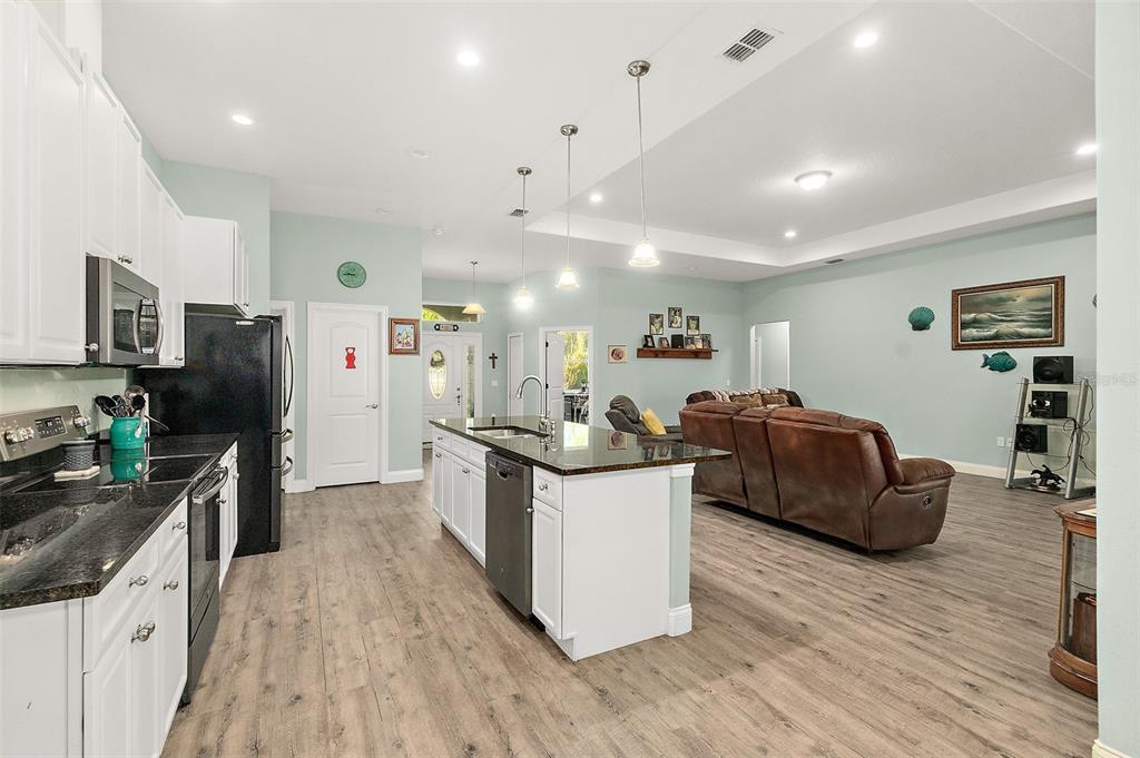 6 Wavecrest Place Palm Coast, FL 32164 - Photo 11 of 22 a kitchen with stainless steel appliances kitchen island granite countertop a stove and a refrigerator