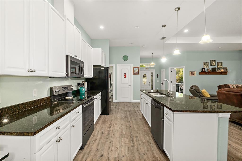 6 Wavecrest Place Palm Coast, FL 32164 - Photo 12 of 22 a kitchen with stainless steel appliances granite countertop a sink stove and refrigerator
