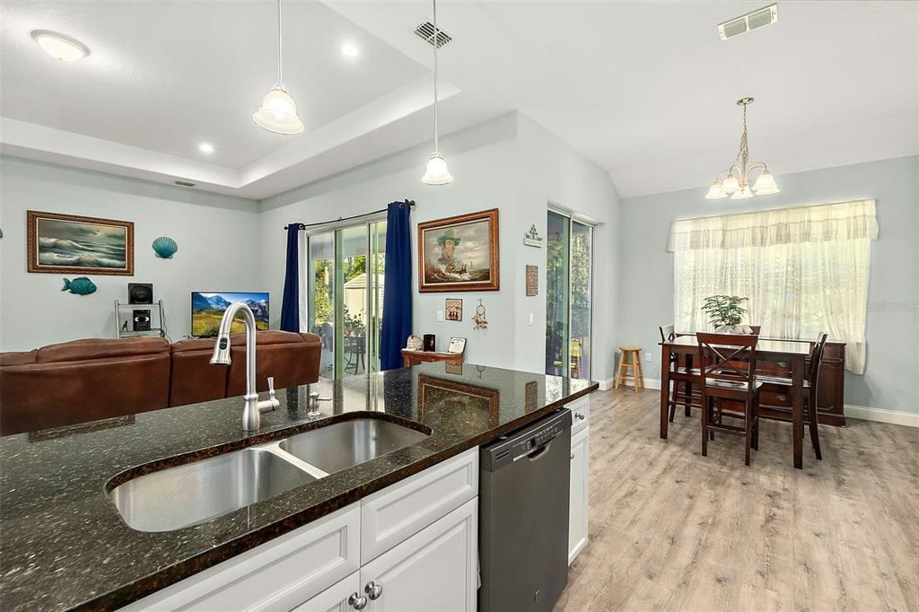 6 Wavecrest Place Palm Coast, FL 32164 - Photo 13 of 22 a kitchen with granite countertop a sink a counter top space and living room view