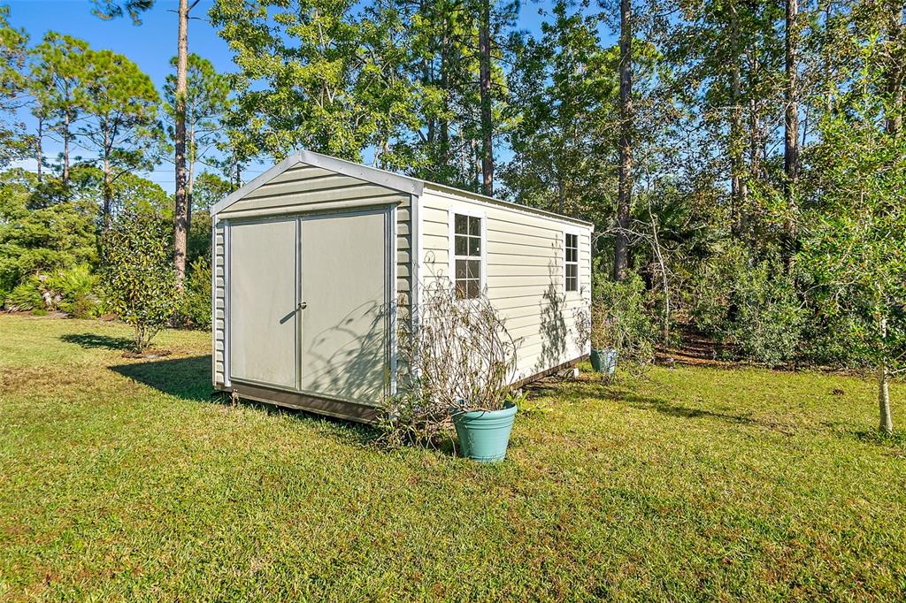 6 Wavecrest Place Palm Coast, FL 32164 - Photo 19 of 22 a front view of a house with garden