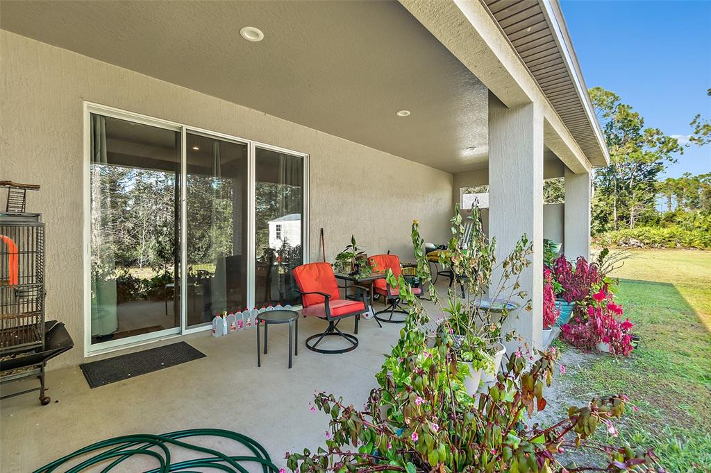 6 Wavecrest Place Palm Coast, FL 32164 - Photo 22 of 22 a outdoor space with chairs and potted plants