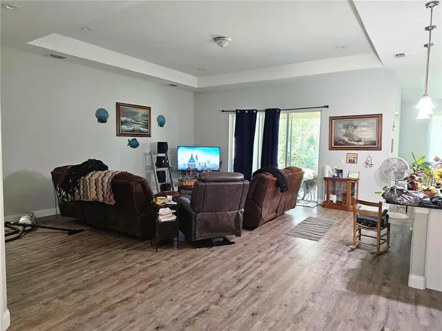 a living room with furniture window and wooden floor