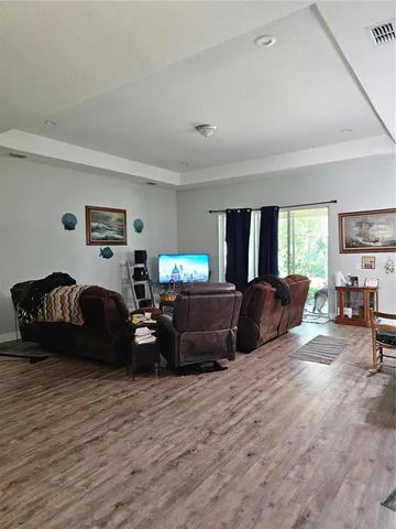 a living room with furniture a couch and a flat screen tv