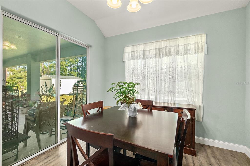 6 Wavecrest Place Palm Coast, FL 32164 - Photo 10 of 22 a view of a dining room with furniture and a potted plant