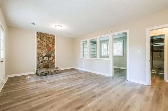 wooden floor in an empty room with a window