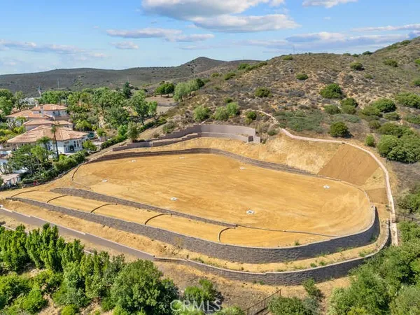 an aerial view of a house with a mountain