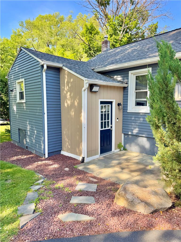 5454 Camp Meeting Road Center Valley, PA 18034 - Photo 27 of 27 A quaint rear entrance with a dark blue door and a small paved patio area.