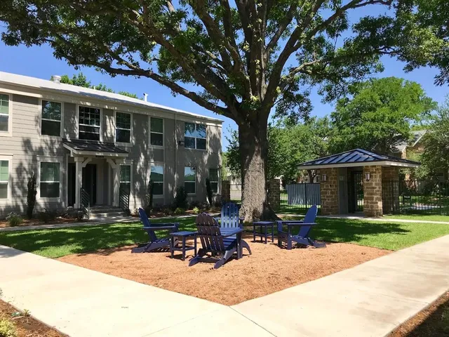 a view of a house with backyard sitting area and garden