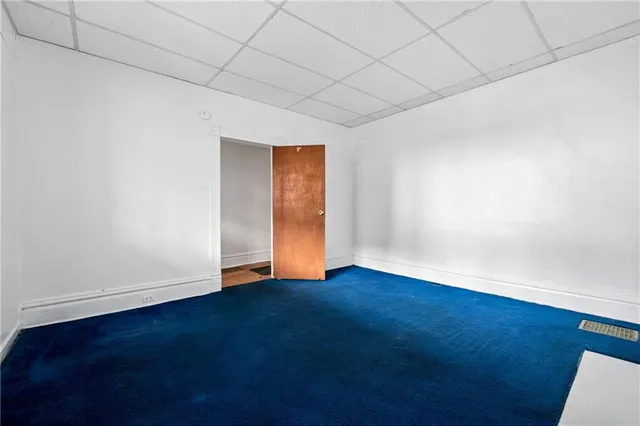 an empty room with wooden floor and closet