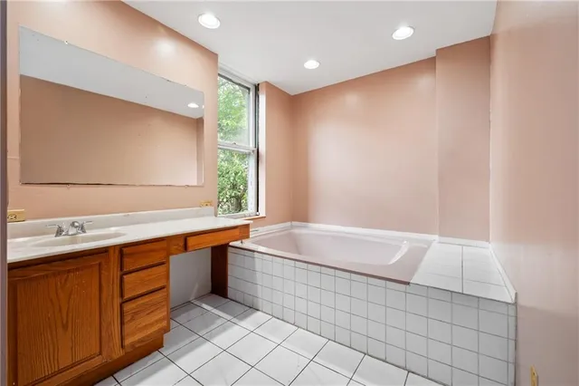 a bathroom with a bathtub and a sink