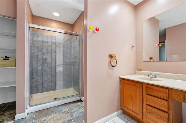 a bathroom with a shower sink and mirror