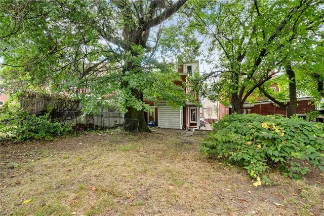 a view of a house with a tree