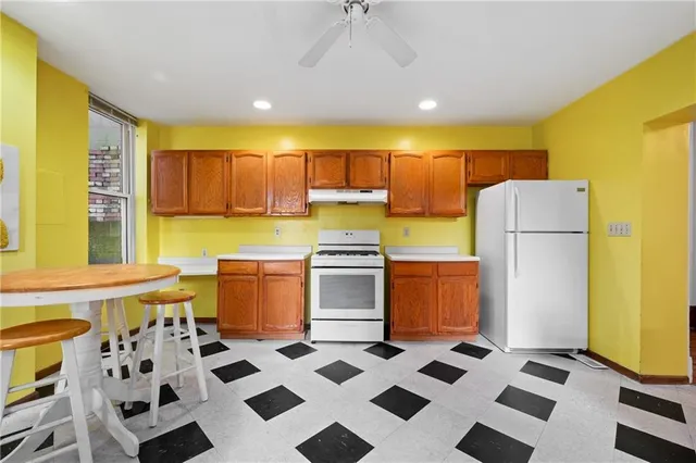 a kitchen with a stove a refrigerator and a cabinets