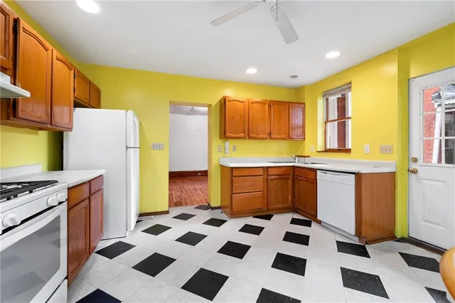 a kitchen with stainless steel appliances granite countertop a stove a refrigerator a sink a microwave oven with island and cabinets