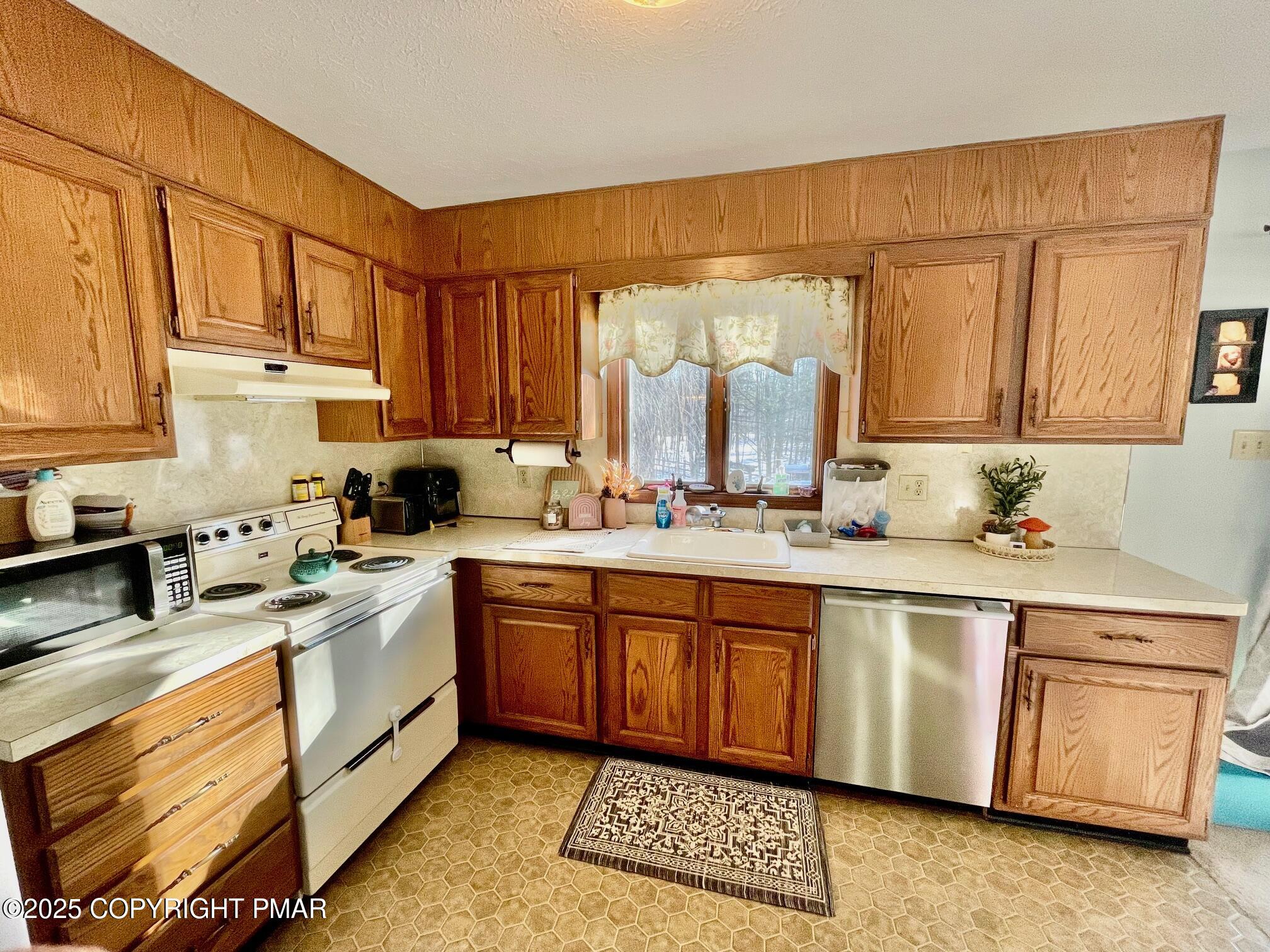 73 Panther Run Road Jim Thorpe, PA 18229 - Photo 26 of 55 a kitchen with stainless steel appliances granite countertop a sink stove and cabinets