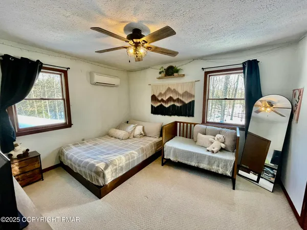a bedroom with a large bed and a chandelier