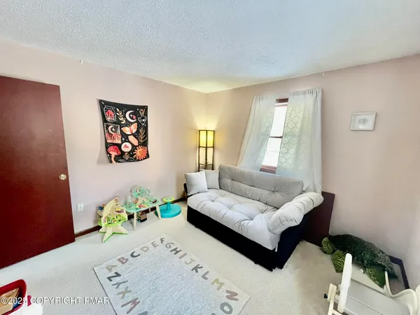 a bedroom with a bed and couch