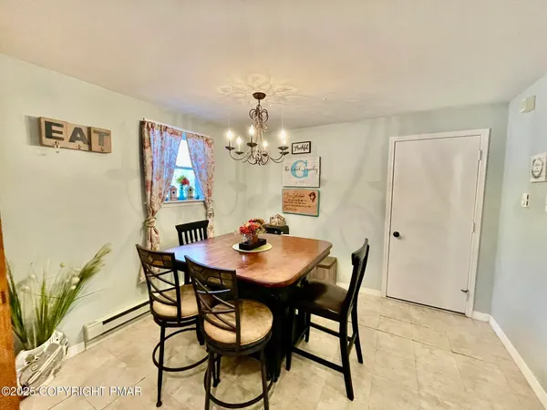 a view of a dining room with furniture and chandelier