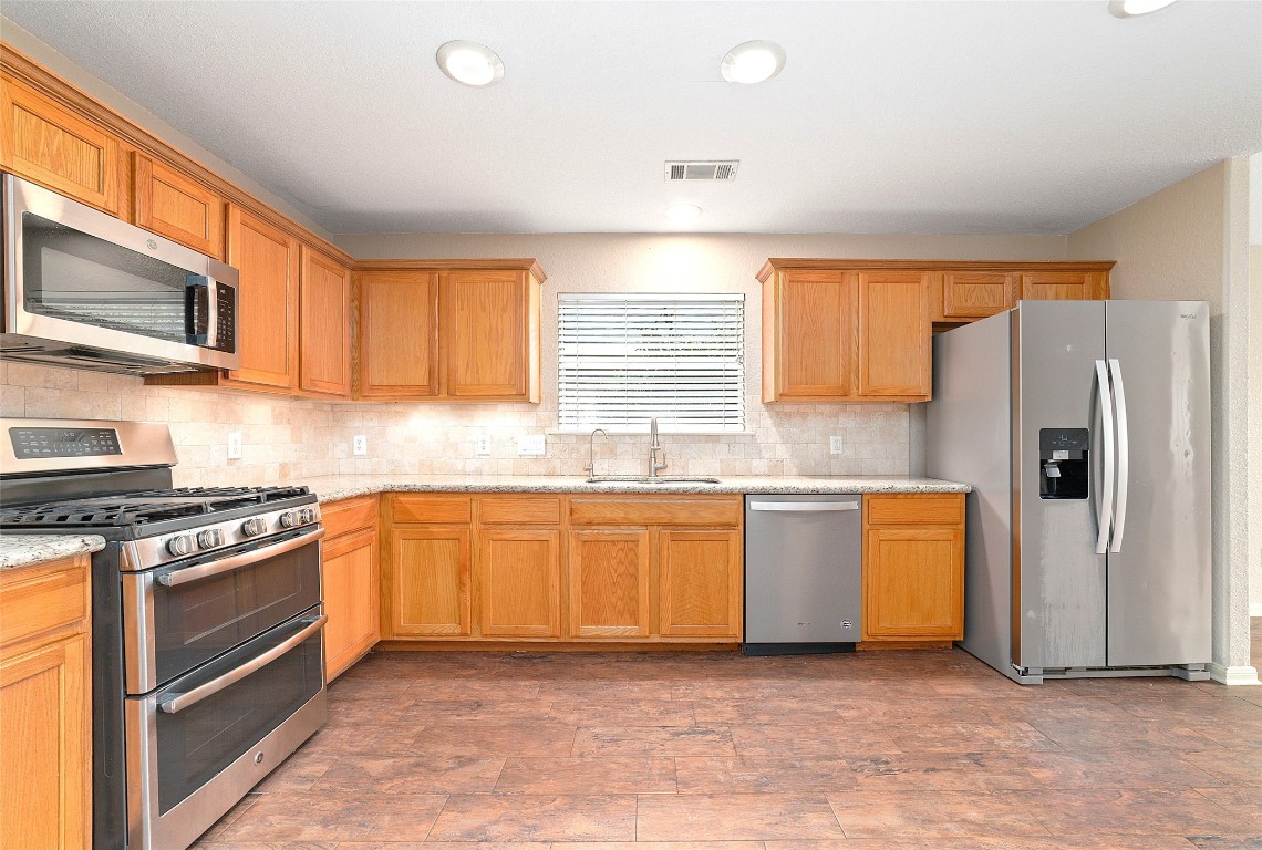 14610 Hazy Ridge Lane Cypress, TX 77429 - Photo 12 of 38 GE gas stove with griddle for your gourmet cooking