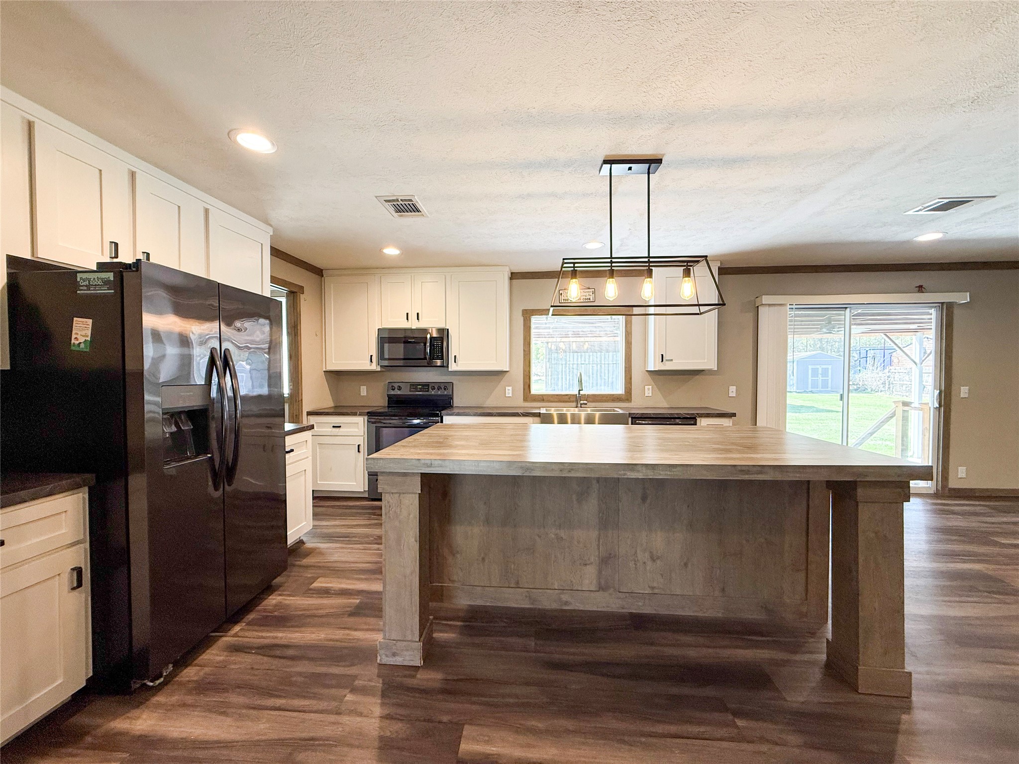 19007 Turtle Creek Way Magnolia, TX 77355 - Photo 3 of 34 a kitchen with kitchen island a sink appliances and cabinets