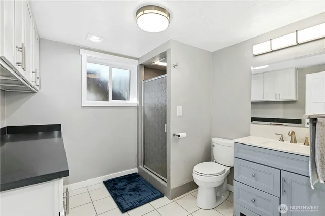 a bathroom with a toilet sink and mirror