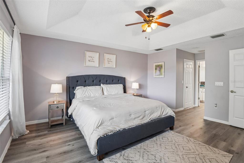 1129 Daleside Lane New Port Richey, FL 34655 - Photo 16 of 34 a bedroom with a bed and a chandelier