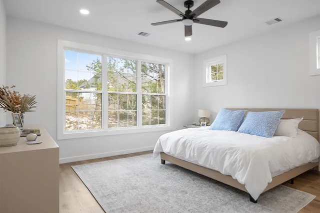 a bedroom with a large bed and a window