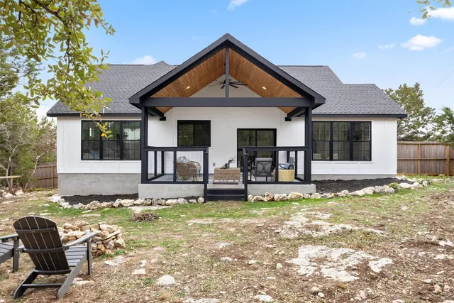 a front view of a house with a yard outdoor seating and garage