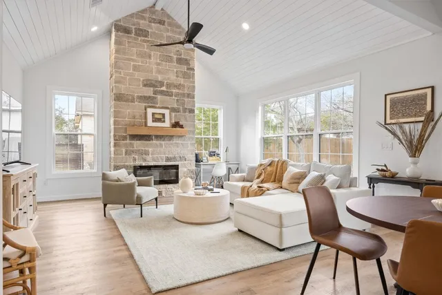 a living room with furniture fireplace and a table